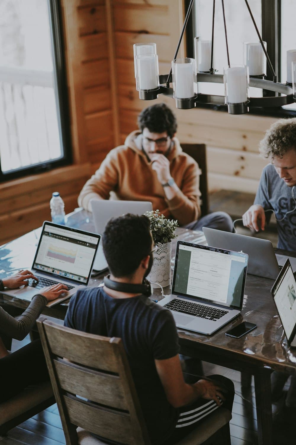 Colleagues talking at a desk in a bright office